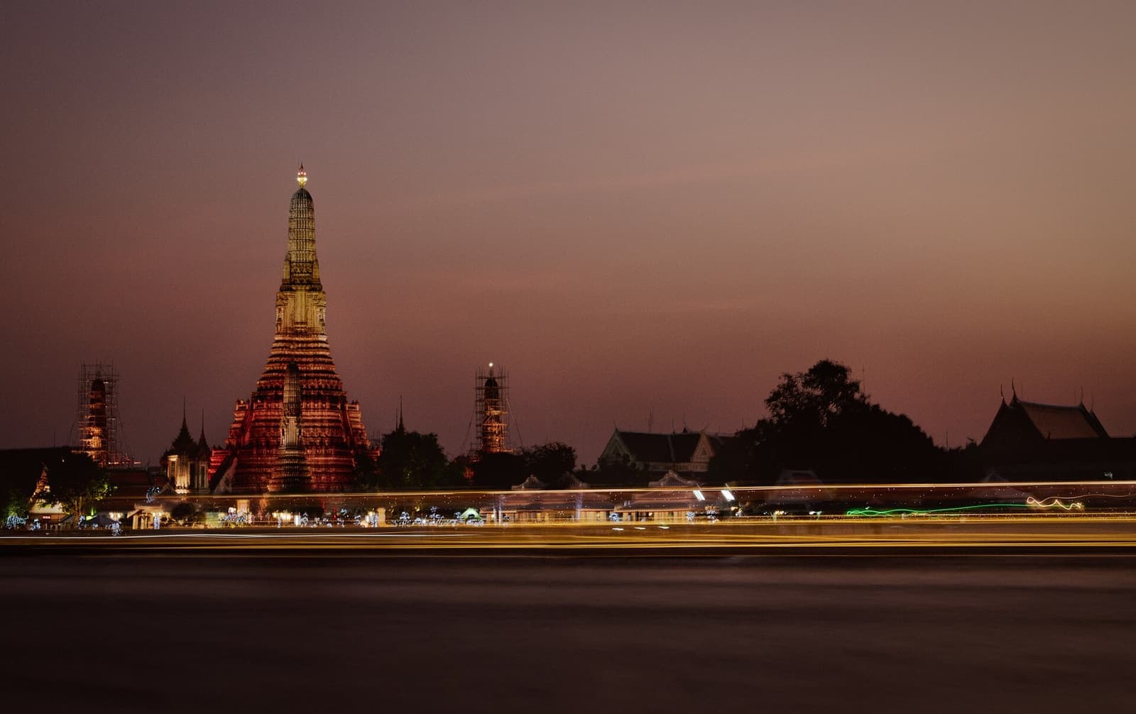 Golden temple spires above the Chao Phraya river in Bangkok