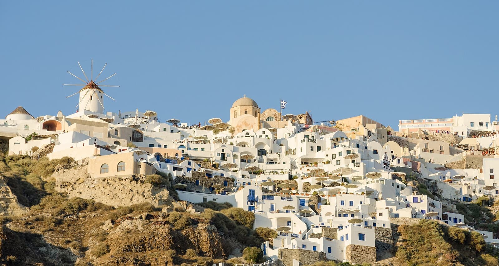White cliffside houses with blue domes in Oia, Santorini