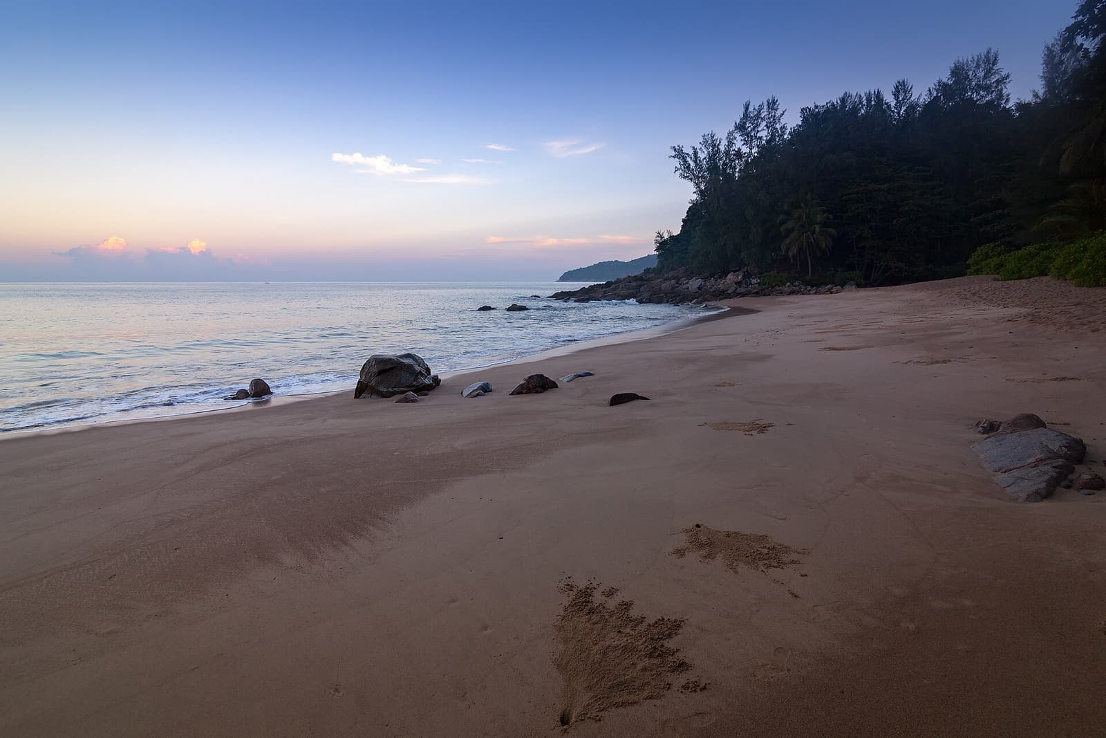 Sandy bay and limestone headland on the coast of Phuket